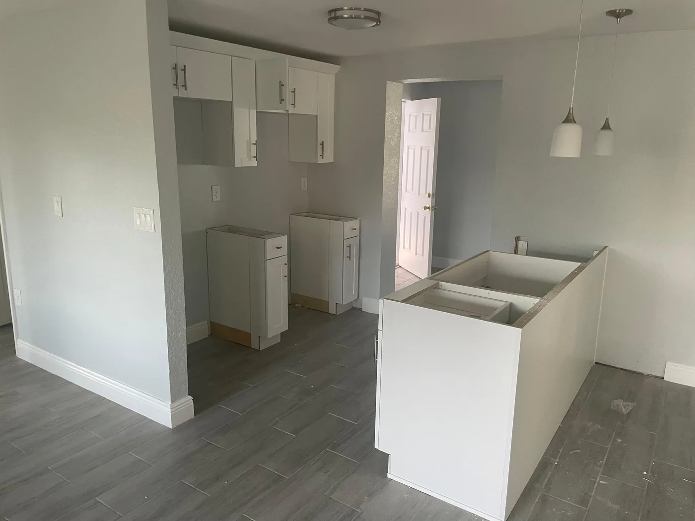 White shaker cabinets going in during a kitchen remodel