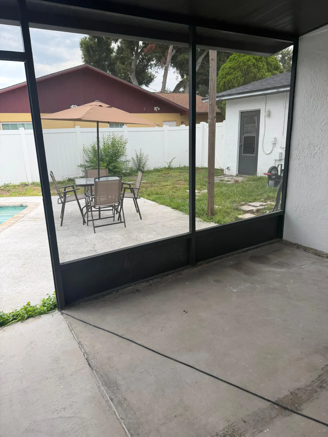 Screened patio enclosure with seating area